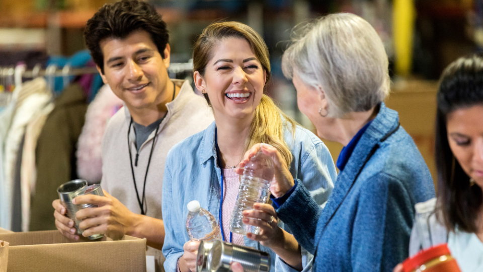 A group of people smiling and working together