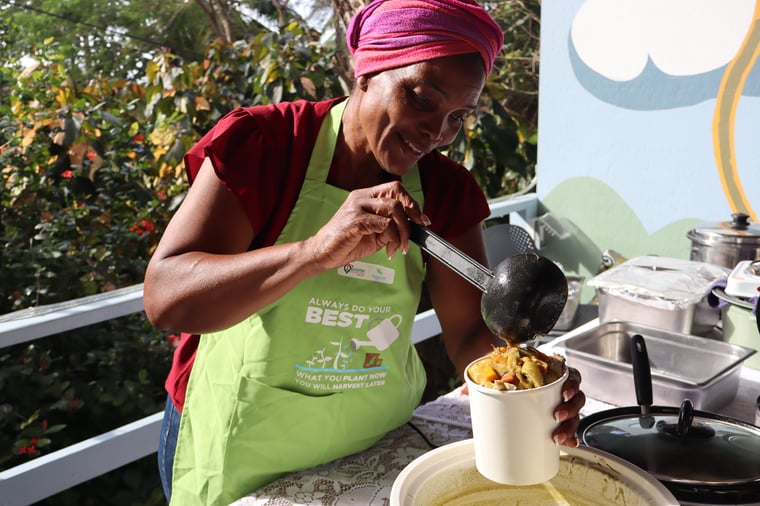 Bernice Chase serving food at an outdoor food station