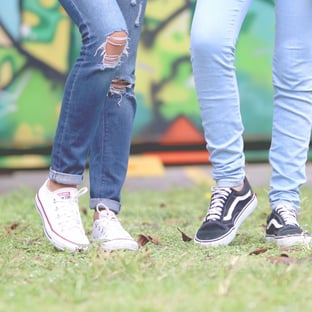 legs of 2 young people standing together