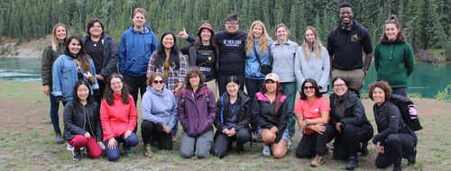 Howl attendees pose in front of a beautiful Yukon landscape