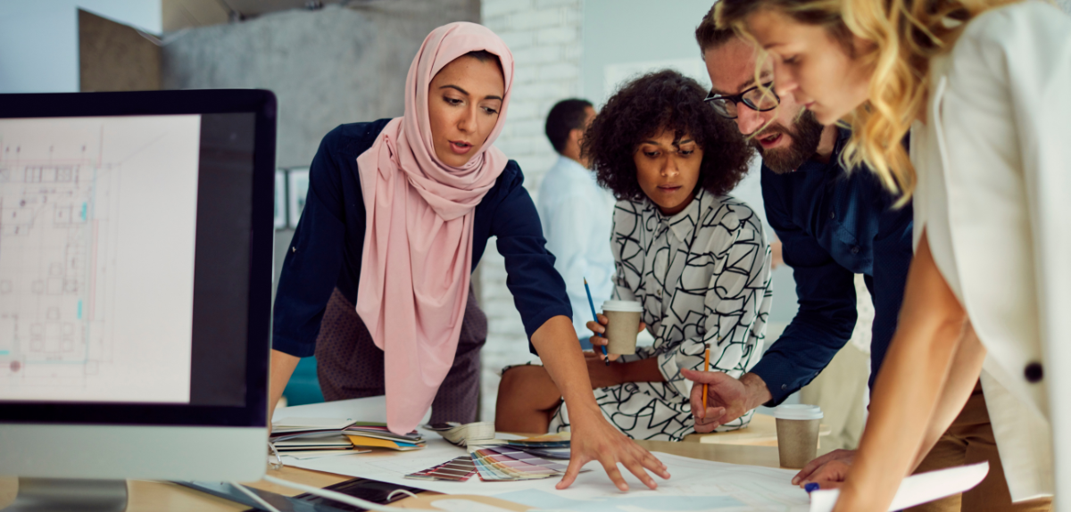 A group of people having a staff meeting