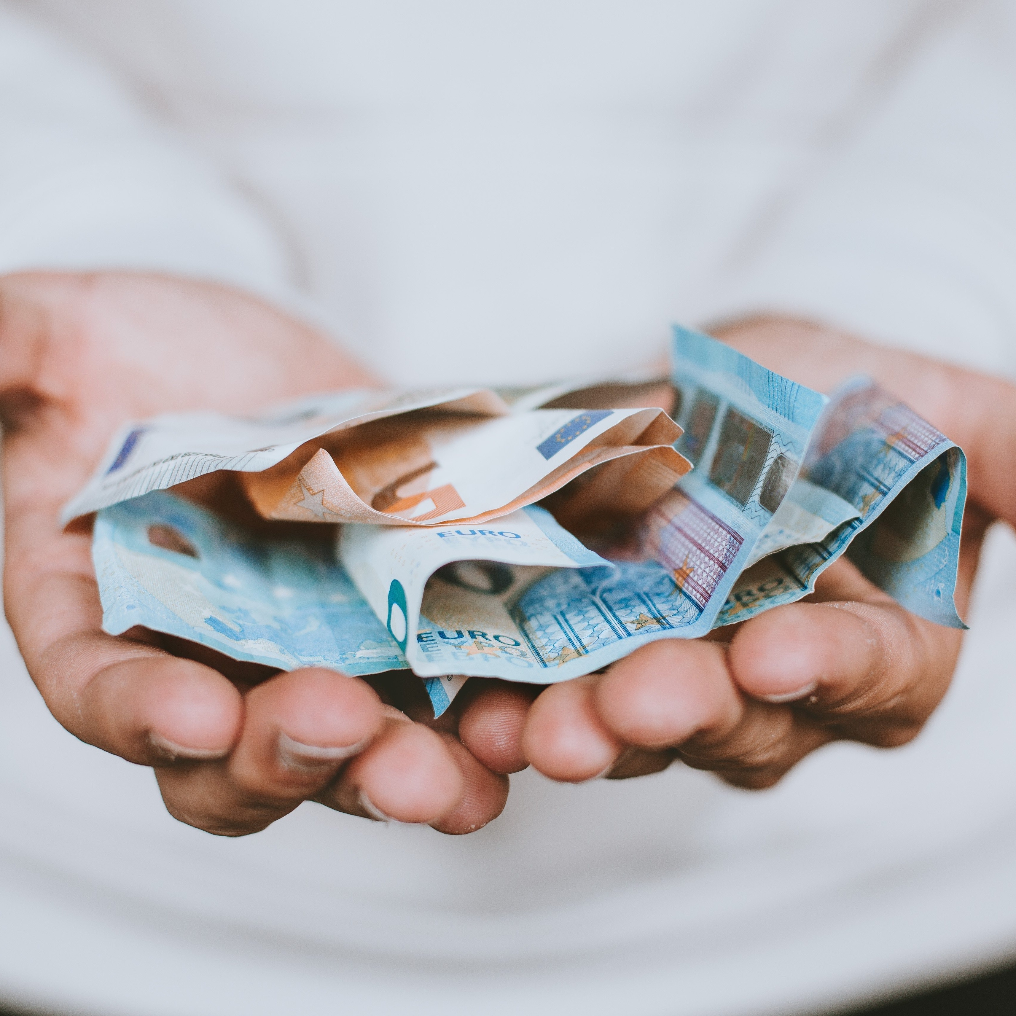 Hands holding money square.jpg