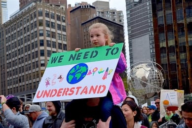 Little girl holding sign to protect environment 3 2 .jpg