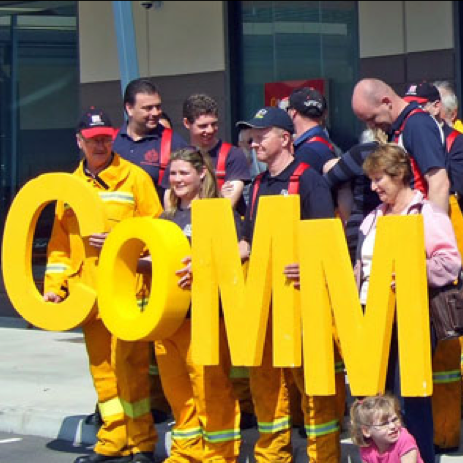 People outside holding Community sign.png