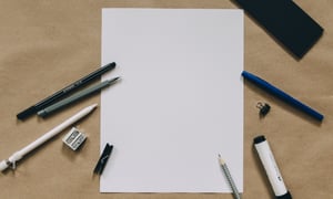 Blank sheet with writing utensils around it-521135-edited