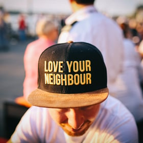 Man wearing love your neighbour hat-108916-edited
