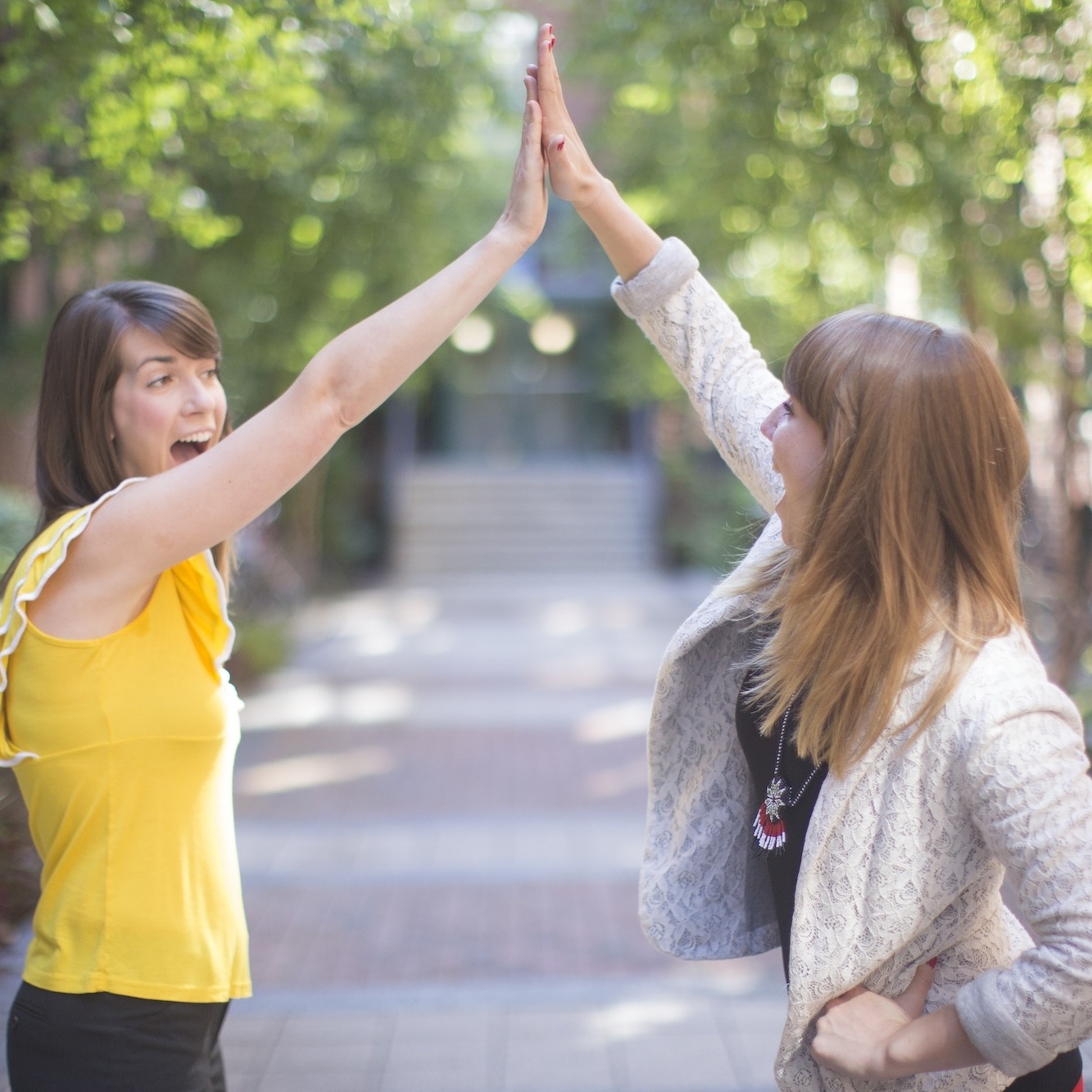 girls high fiving