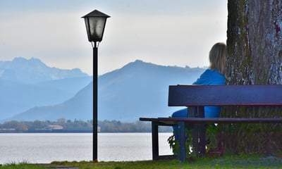 woman sitting on bench with mountains-465171-edited