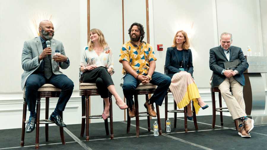 Photo of Tamarack Consulting Director of Community Engagement Lisa Attygalle onstage as part of a panel discussion