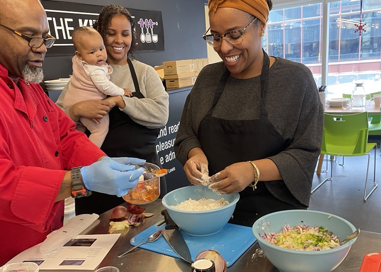 Image of members of the Community of Care participating in a cooking workshop facilitated by the Bajan Chef as part of their Breaking of Bread Ceremony