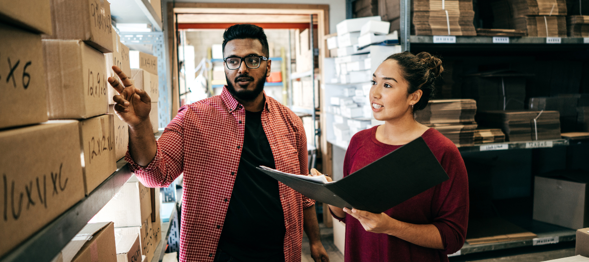 Two people speaking as they review inventory