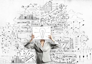 Businesswoman hiding her face with sheet of paper with sketches at background.jpeg Businesswoman hiding her face with sheet of paper with sketches at background.jpeg