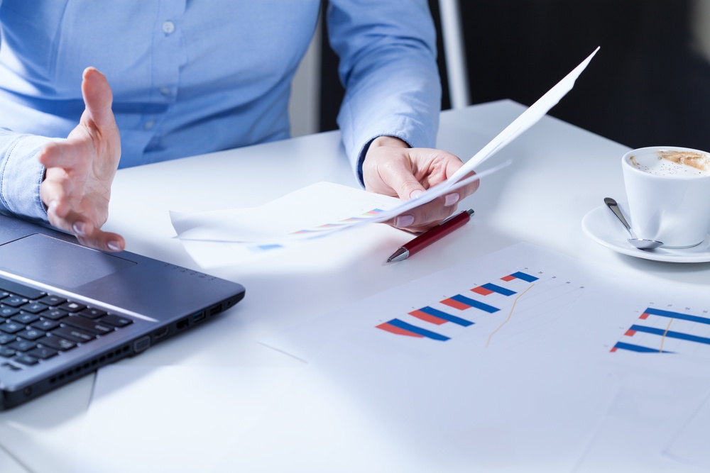 Close-up of young businesswoman holding survey results.jpeg
