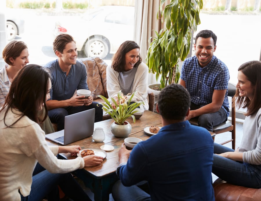 A group sits around a table chatting