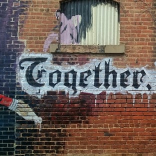 brick wall with together written across