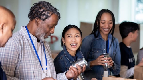People laughing and working together in a community.