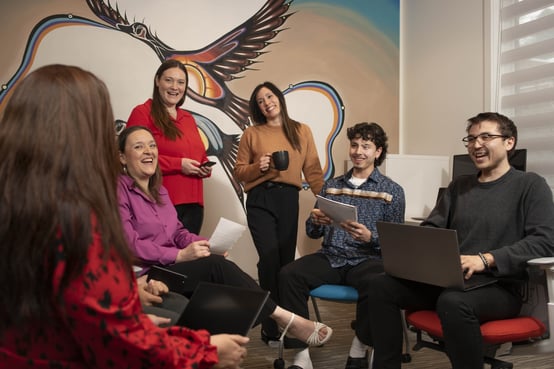 Indigenous coworkers laughing together