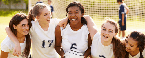A soccer team laughing and smiling together