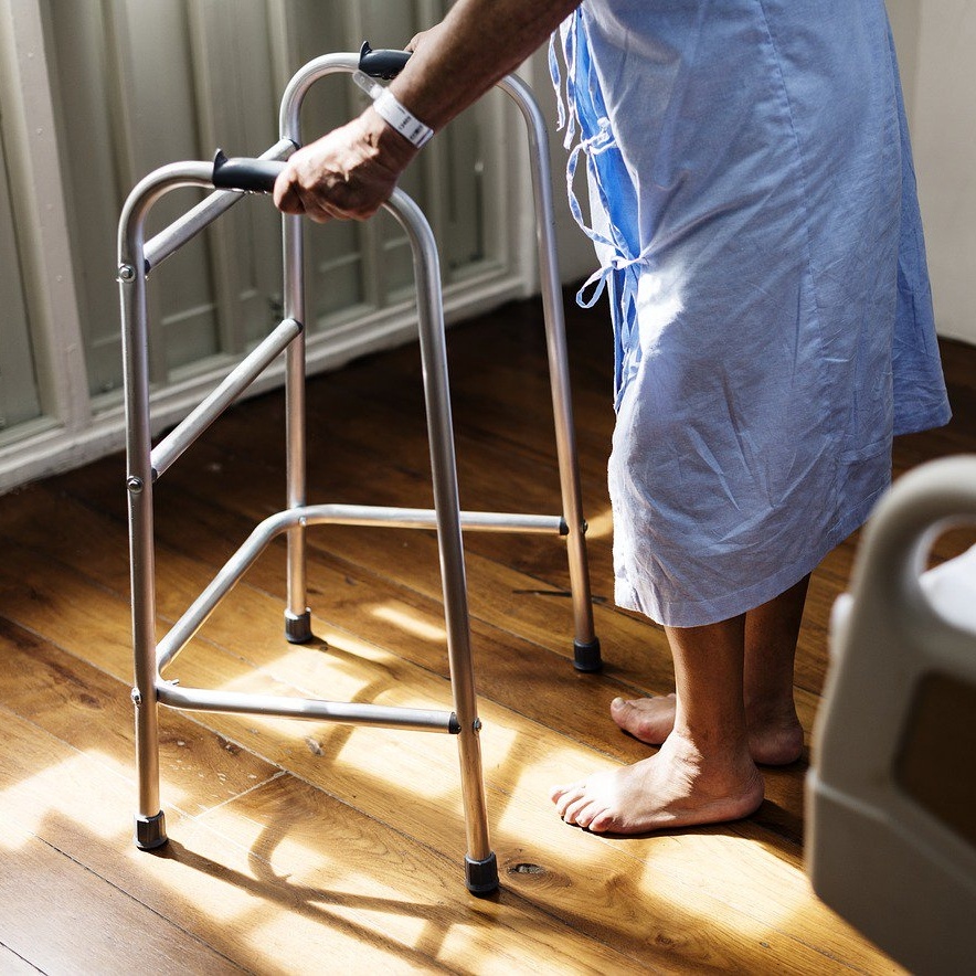 patient in hospital using walker square crop.jpg