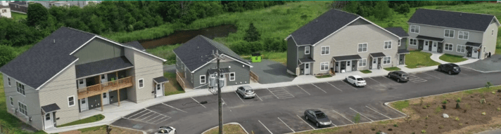 A building with cars parked in front of it

Description automatically generated