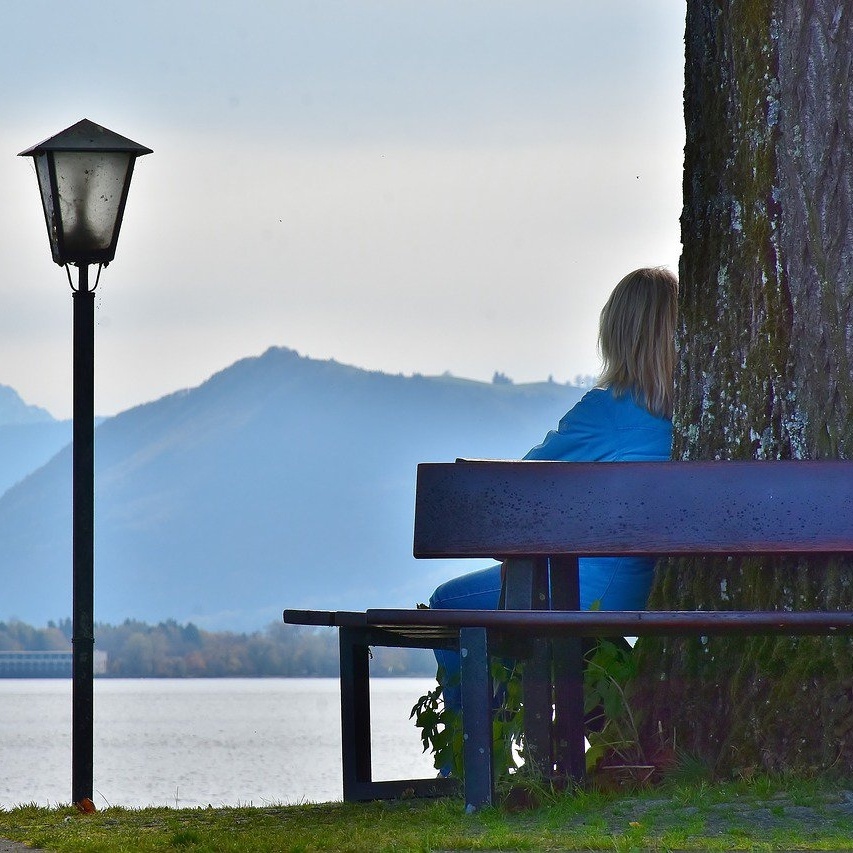 woman sitting on bench with mountains square.jpg