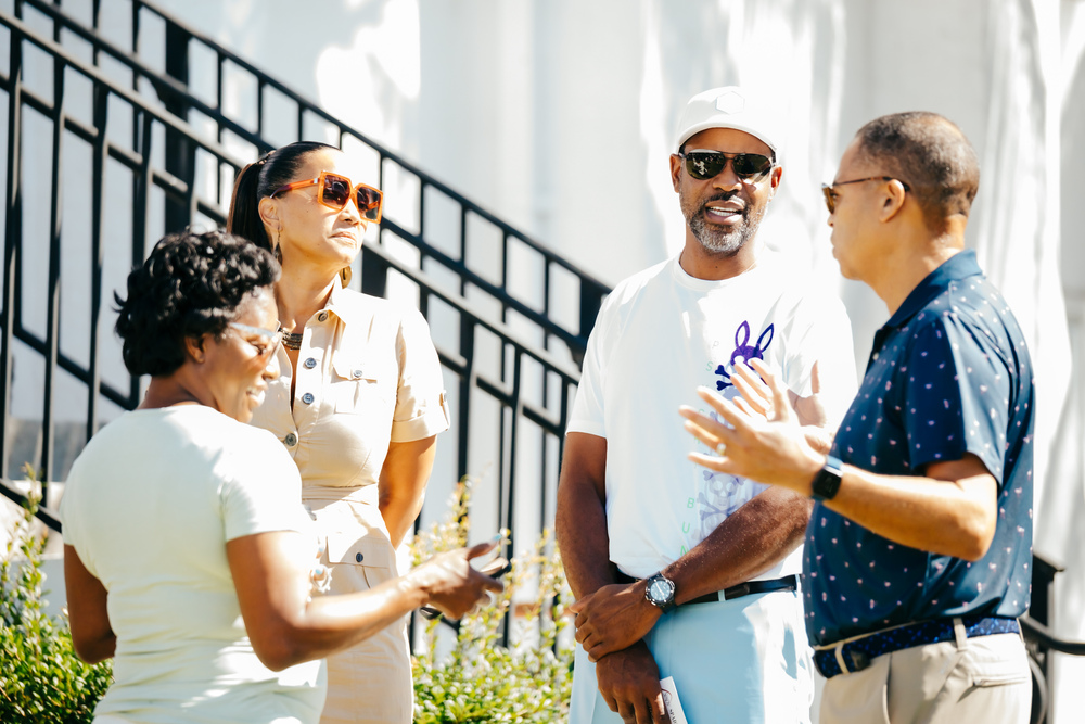 diverse-group-people-standing-outside-talking-sunny-day