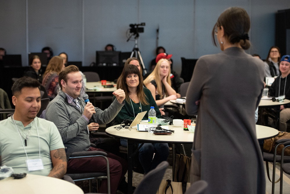 person-asking-question-microphone-audience-group-gathering