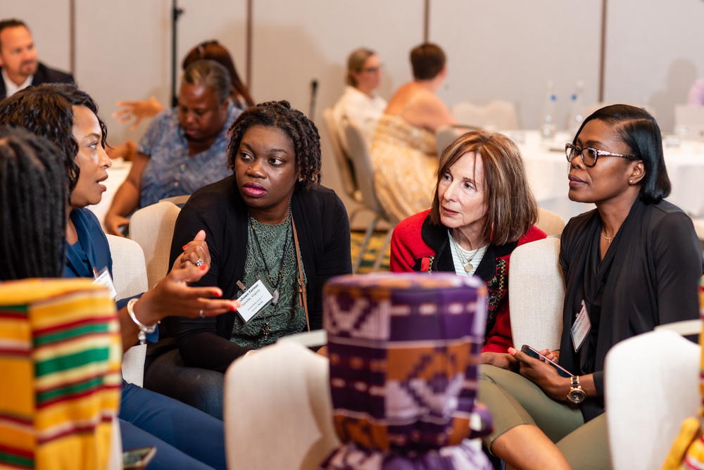 diverse-group-four-women-engaging-conversation