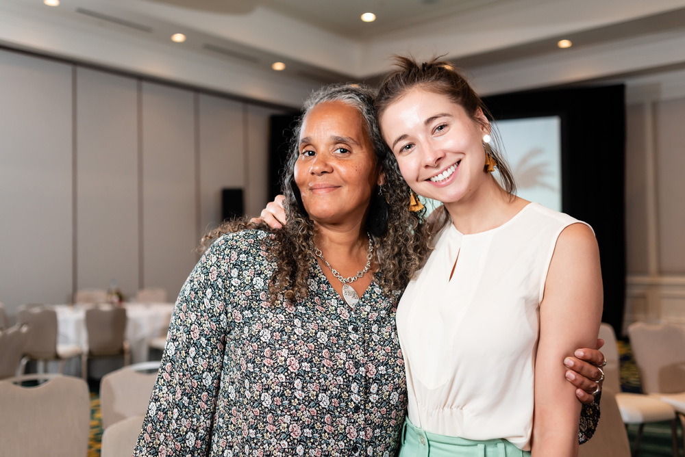 two-women-smiling-standing-together-embrace-diversity