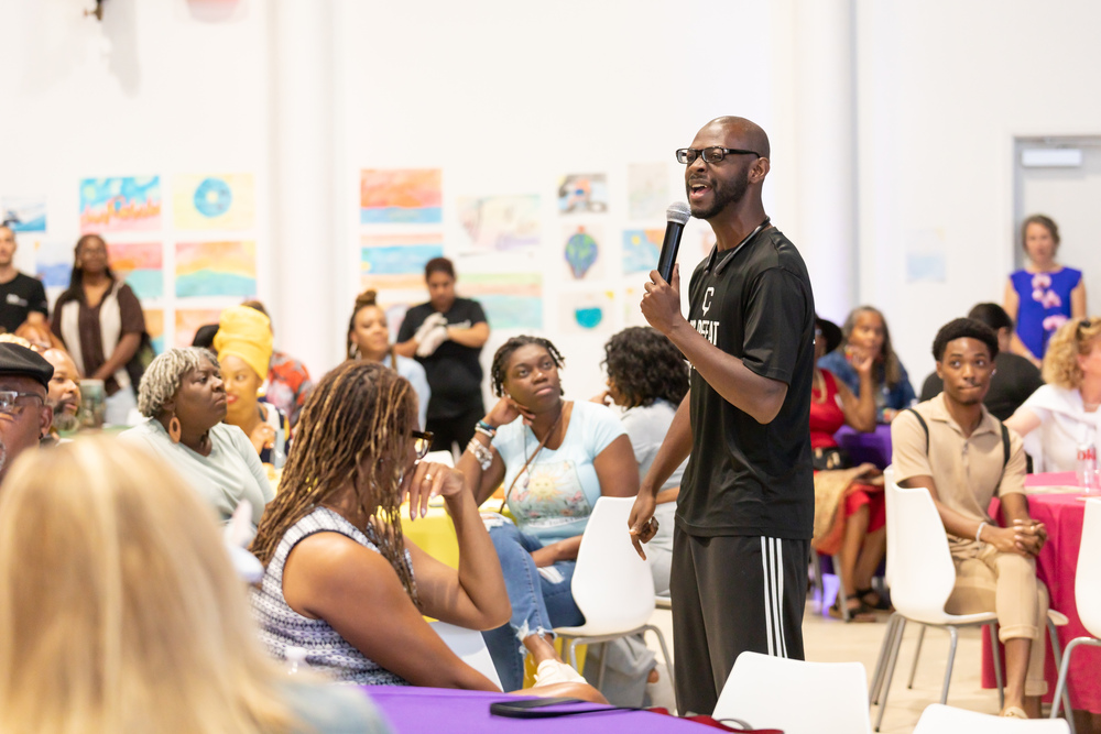 man-speaking-microphone-diverse-crowd-event-gathering man-speaking-microphone-diverse-crowd-event-gathering