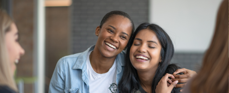 Friends embracing and smiling together