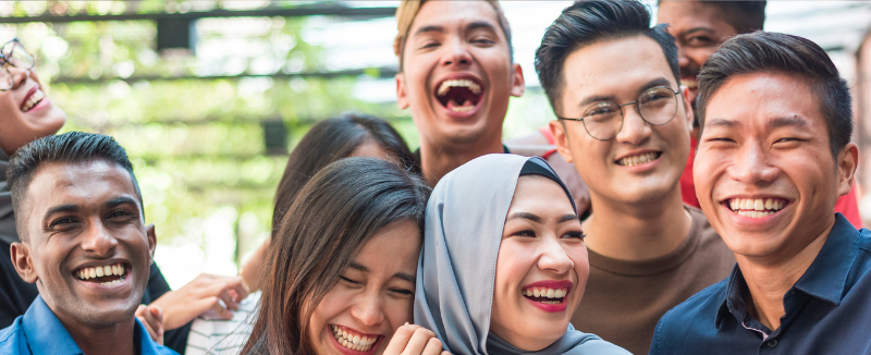 Group of people laughing and smiling together